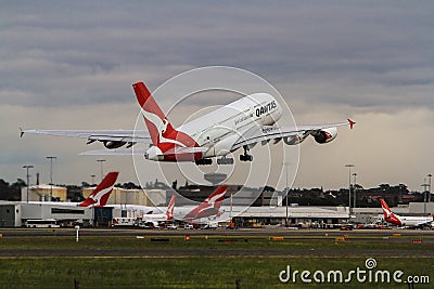 Qantas Airbus A380 taking off among company jets