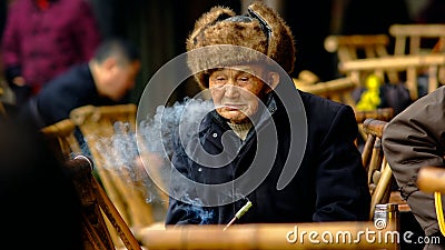 Qianwei China-An old man Spit smoke