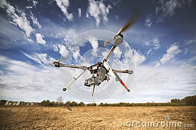 Quadrocopter drone flying in the sky