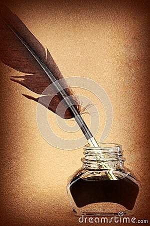 Quill pen in glass ink bottle