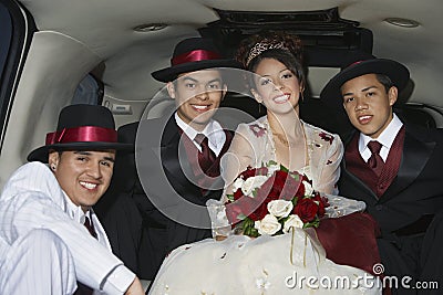 Quinceanera Sitting With Three Male Friends In Limousine