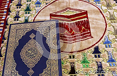 Qur an and Muslim prayer carpet