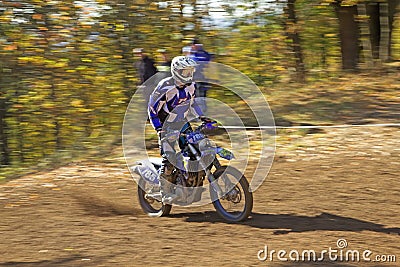 Racer in blue is riding motorcycle