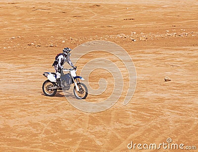 Racer on a motorcycle ride through the desert