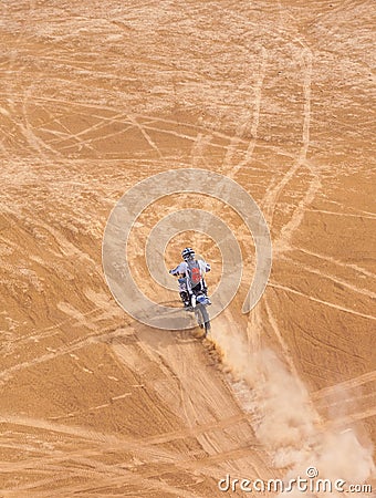 Racer on a motorcycle ride through the desert