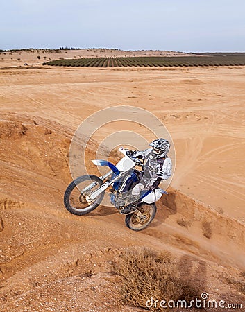 Racer on motorcycle rides into the mountain