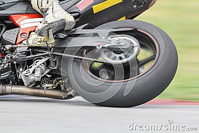 Racing bike rider leaning on track