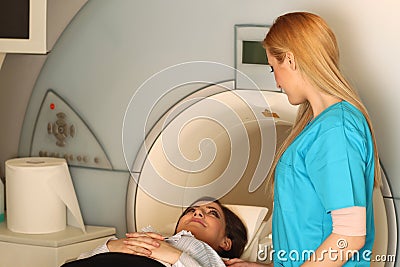 Radiologic technician on a CT Scan bed