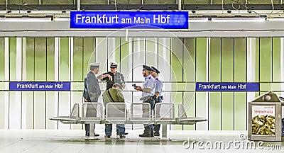 Railway policemen check a passenger for a valid ticket at Frankfurt Main Station