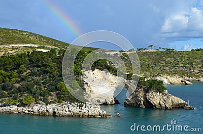 Rainbow over the rock window near Vieste