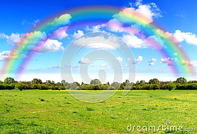Rainbow sky clouds and grass on meadow