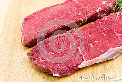 Raw beef-roast beef meat steak on the wooden backg