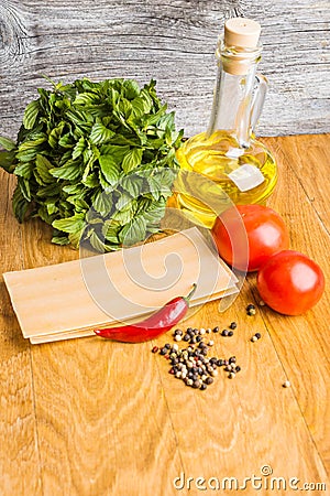 Raw lasagna with pepper and oil in the cooking process