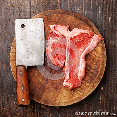 Raw meat T-Bone Steak and meat cleaver