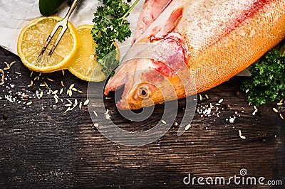 Raw rainbow trout fish preparation on old wooden table