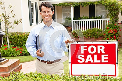 Real estate agent standing outside house