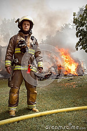 Real Firefighter with house on fire in background