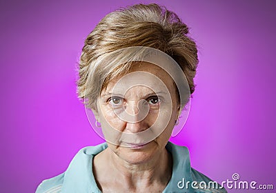 Real serious woman portrait over purple background