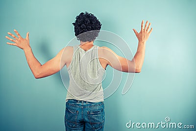 Rear view of man with arms raised