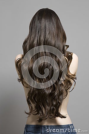 Rear View Of Topless Woman With Long Wavy Hair