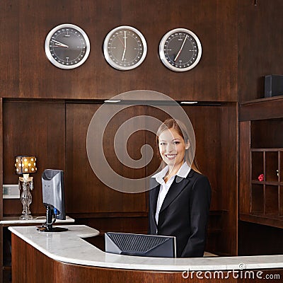 Receptionist behind counter at hotel