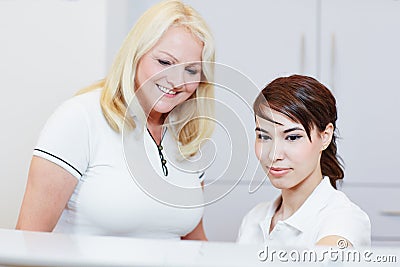 Receptionist with doctor at reception