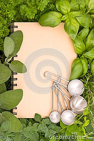 Recipe book with variety fresh herbs