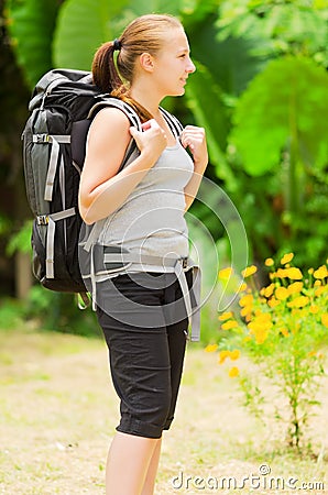 Young woman with backpack in a woods