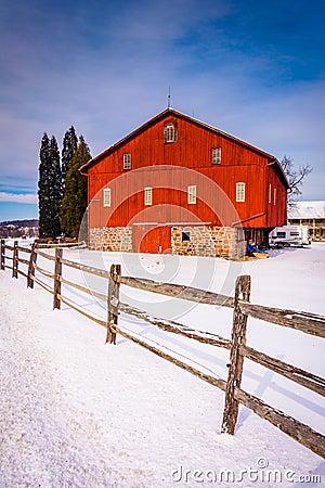 Red barn and fence in a snow-covered farm field in rural Adams C