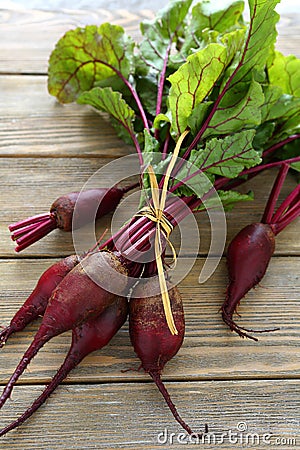 Red beets with tops on the boards