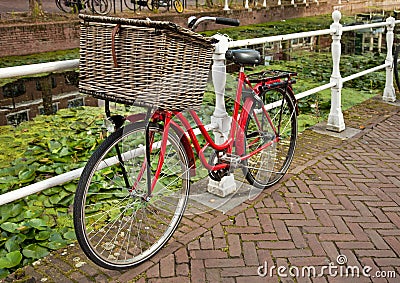 Red Bicycle Beside a Canal in Netherlands