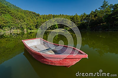 Red boat in lake and reflection