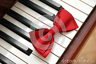 Red bow tie on the piano keys