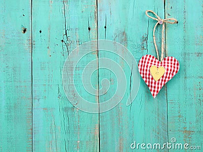 Red checkered and gold hearts handing on antique green wood door