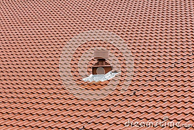 Red chimney on the roof composed of red tiles