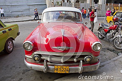 Red classic Cuban Car diagonal parking in street 2