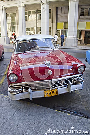 Red classic Cuban Car diagonal parking in street