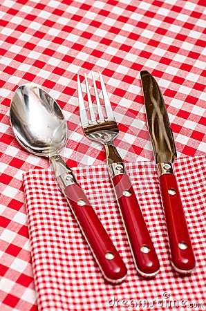 Red cutlery on a napkin in a restaurant