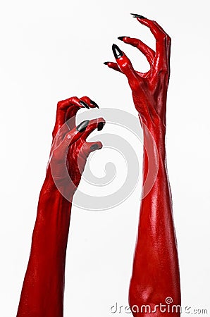 Red Devil s hands with black nails, red hands of Satan, Halloween theme, on a white background, isolated