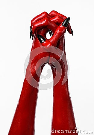 Red Devil s hands with black nails, red hands of Satan, Halloween theme, on a white background, isolated