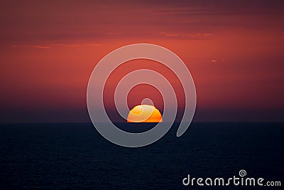 Red disk of the sun. Sea sunset.