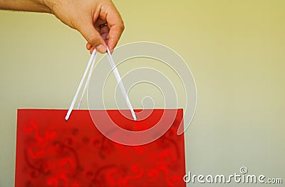 Red gift bag in man s hand