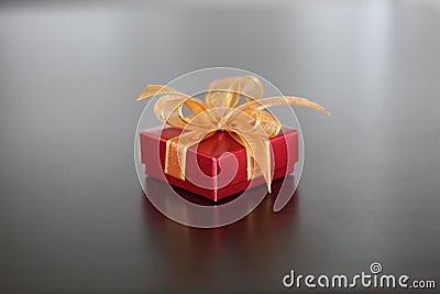 Red gift with golden ribbon