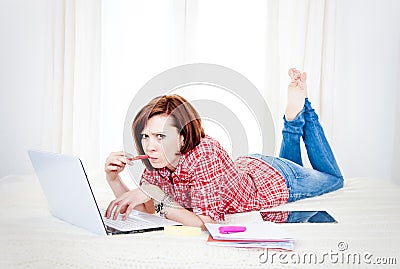 Red hair student, business woman lying down working on laptop