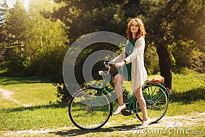 Red-hair woman riding a bicycle