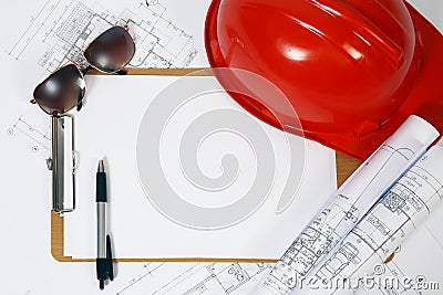 Red hard hat and blueprints