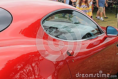 Red italian sports car door handle and window