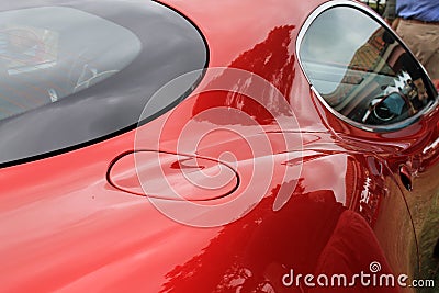 Red italian sports car fuel door and window