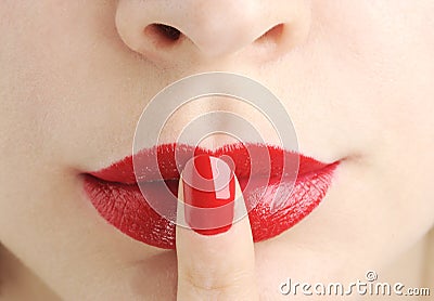 Red lips with finger do silence