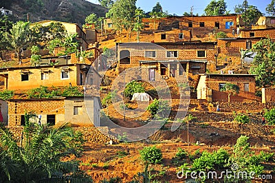 Red mud houses in a village in the African jungle